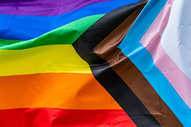 Inclusive Progress Pride Flag with rainbow, black, brown, light blue, pink, and white stripes representing diversity