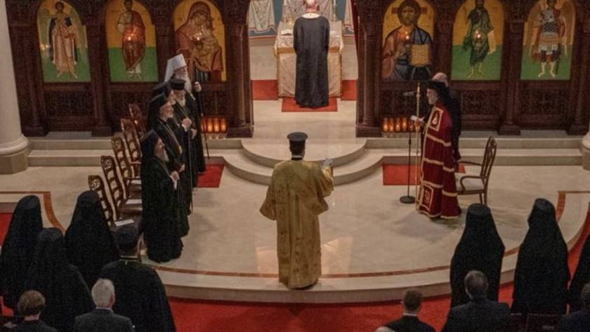 Orthodox clergy in ornate vestments during Divine Liturgy, standing before icons on an altar