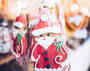 Santa-themed gingerbread cookies in festive packaging at a holiday market display