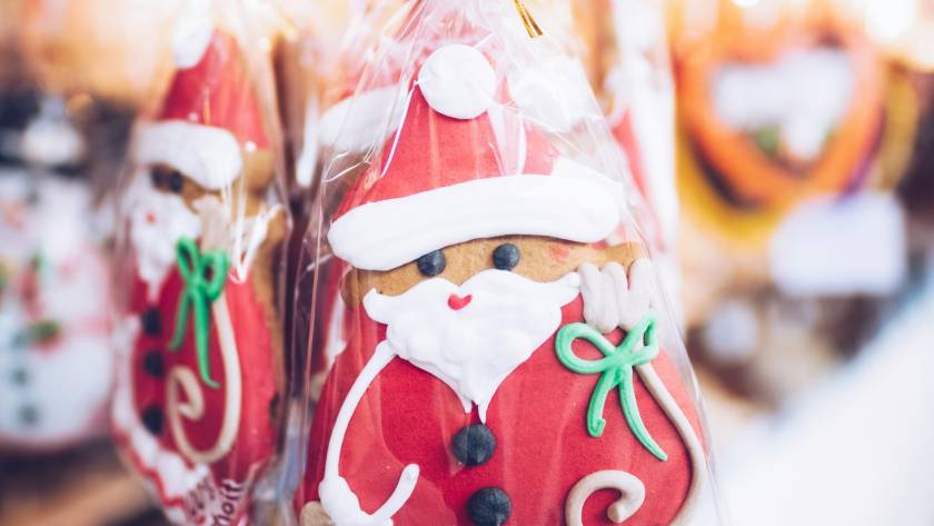 Santa-themed gingerbread cookies in festive packaging at a holiday market display