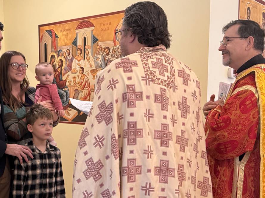 Family gathering with clergy in religious setting, colorful iconography background