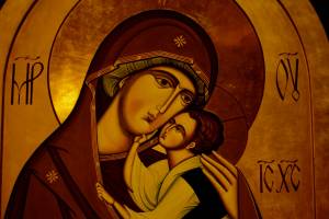 Iconography of mother and child with halos, showcasing traditional religious art style and rich golden tones