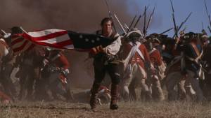 Revolutionary War soldier leading charge with flag amidst battle scene
