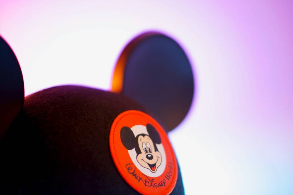 Mickey Mouse ear hat with vibrant background at Walt Disney World-themed event display