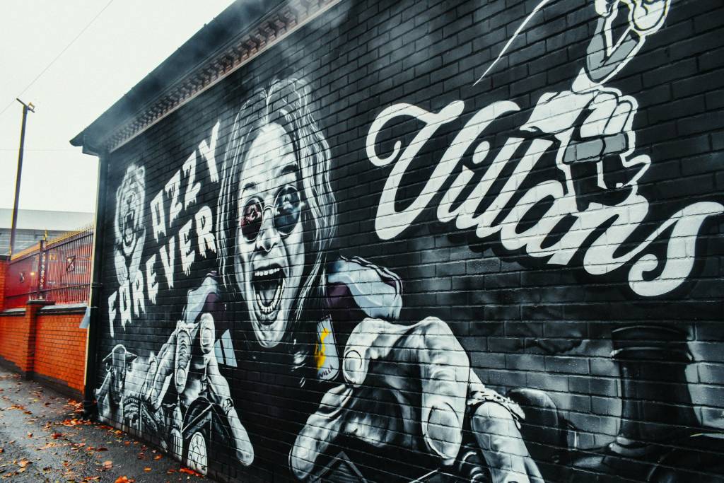 Street art mural with a dynamic figure, text Ozzy Forever and Villains, featuring vivid expressions and bold design