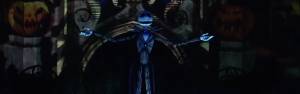 Spooky skeletal figure in striped suit with outstretched arms against a dark, pumpkin-themed background